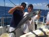 Capt Tito with a big kingfish caught aboard the Catch My Drift.jpg